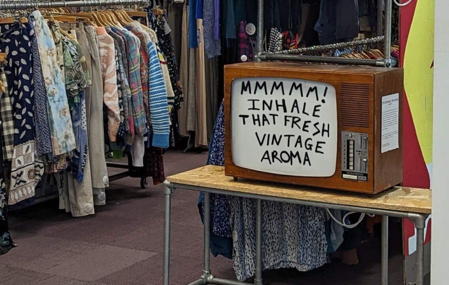 Photo of the Blue Rinse vintage shop in Leeds, with racks of clothes and an old TV.