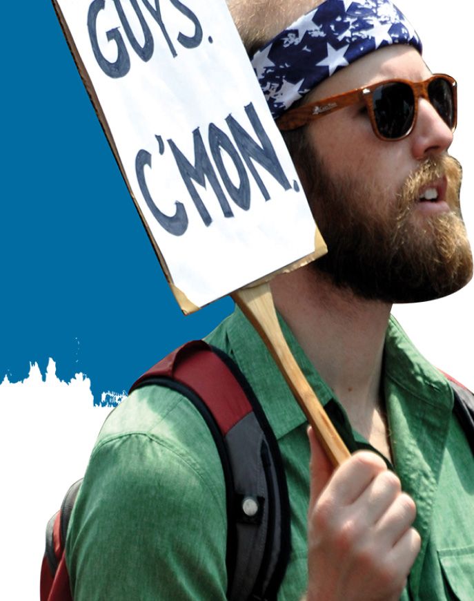 Protester holding a sign reading 'Guys. C'mon.'