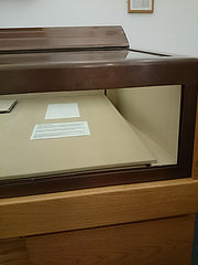 The photo shows an empty display case in a museum